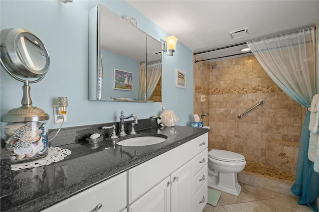 full bath with toilet, vanity, visible vents, a shower stall, and tile patterned floors