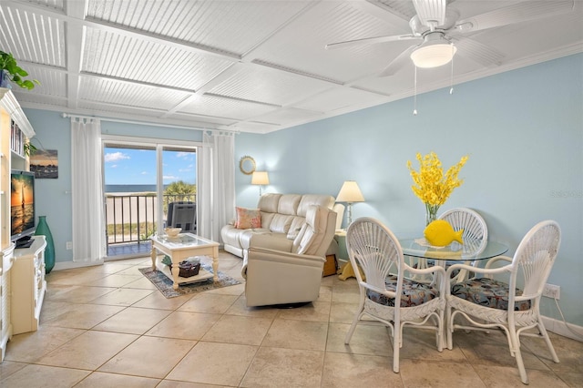 living area with ceiling fan, baseboards, and light tile patterned floors