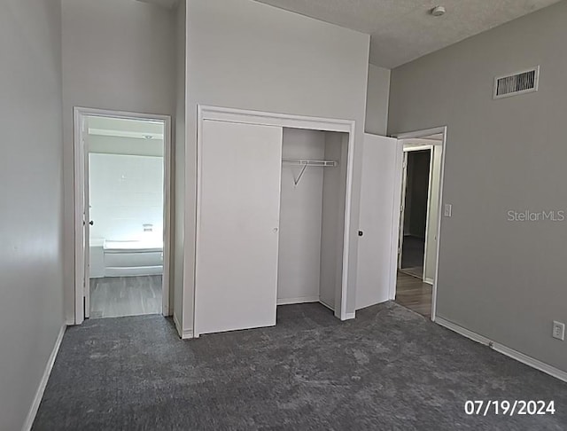 535 Monterey Blvd NE, Saint Petersburg, FL 33704 - unfurnished bedroom featuring dark carpet and a closet