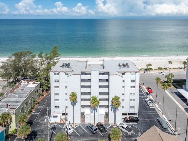 bird's eye view with a water view and a beach view