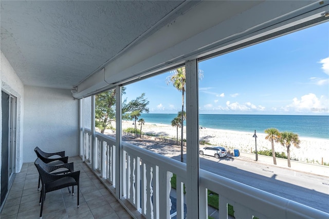 balcony with a view of the beach and a water view