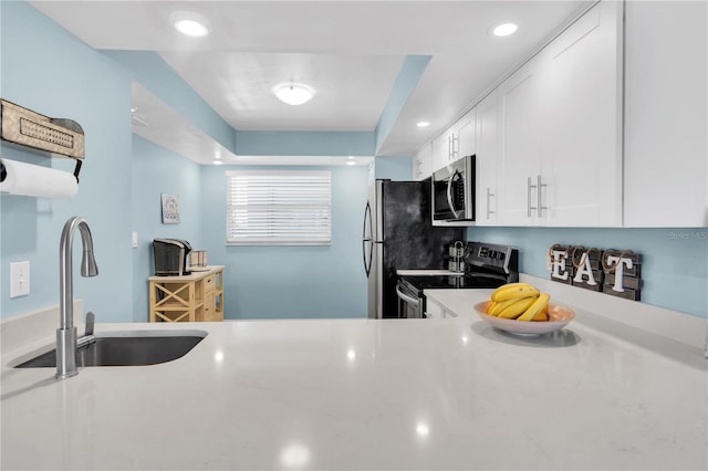 kitchen with white cabinetry, appliances with stainless steel finishes, and sink