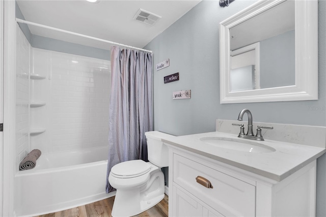 full bathroom featuring toilet, hardwood / wood-style floors, vanity, and shower / bath combo with shower curtain