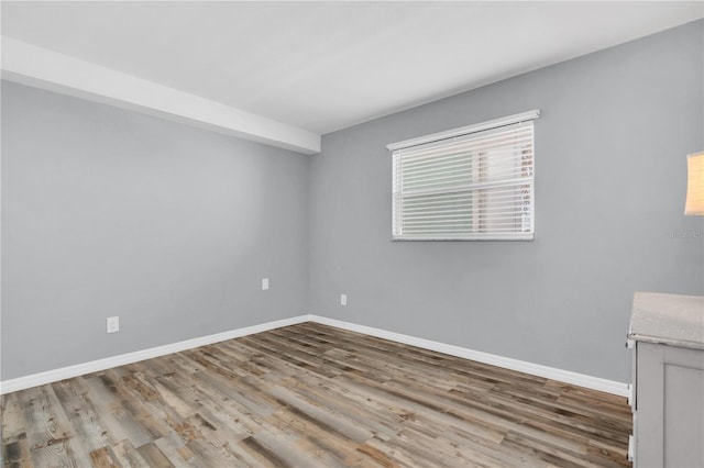 empty room with light hardwood / wood-style flooring