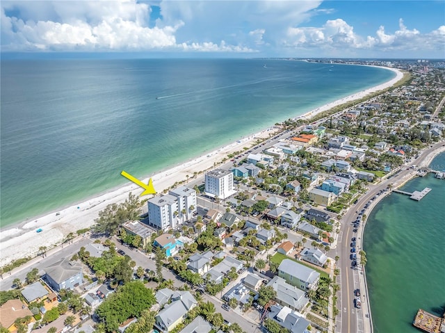 birds eye view of property with a water view and a beach view