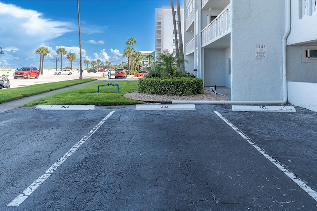 view of vehicle parking featuring a lawn