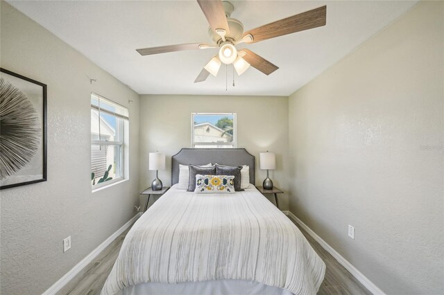 bedroom with ceiling fan and light hardwood / wood-style flooring