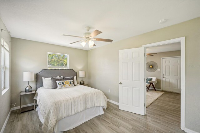 bedroom featuring ceiling fan and light hardwood / wood-style floors