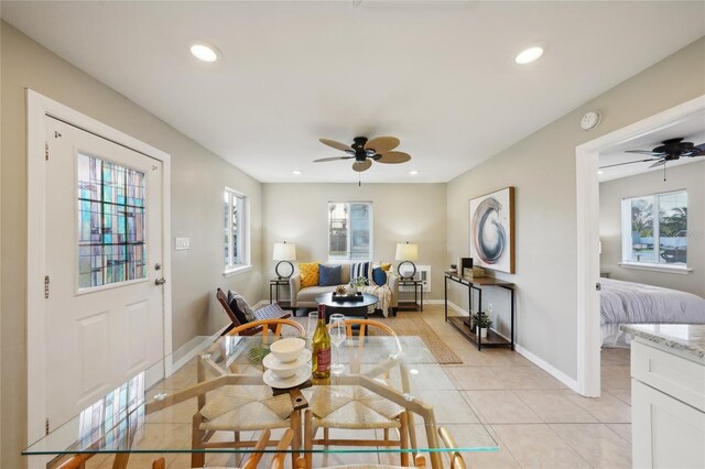 dining space featuring ceiling fan and light tile patterned floors