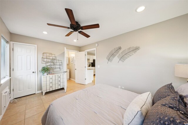 bedroom with ceiling fan and light tile patterned floors