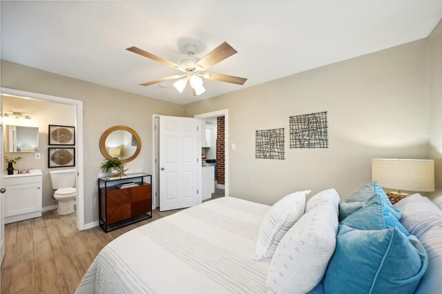 bedroom with ceiling fan, ensuite bathroom, and light hardwood / wood-style flooring