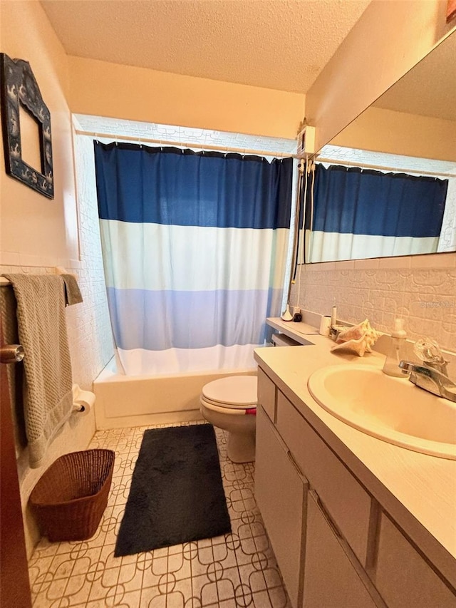 full bathroom with toilet, tile patterned flooring, vanity, a textured ceiling, and shower / bathtub combination with curtain