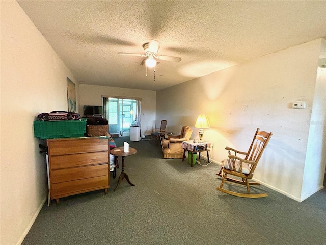 sitting room featuring a textured ceiling, ceiling fan, and carpet