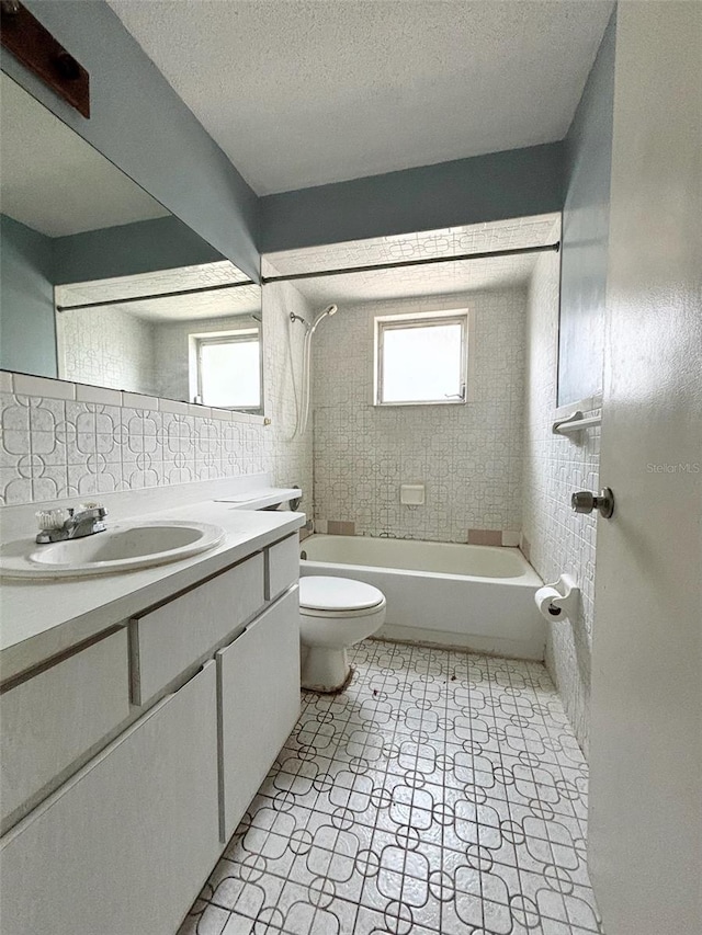 full bathroom featuring tile patterned floors, a wealth of natural light, shower / bathing tub combination, and vanity