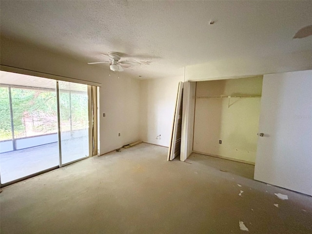 unfurnished bedroom with multiple windows, a textured ceiling, access to exterior, and ceiling fan