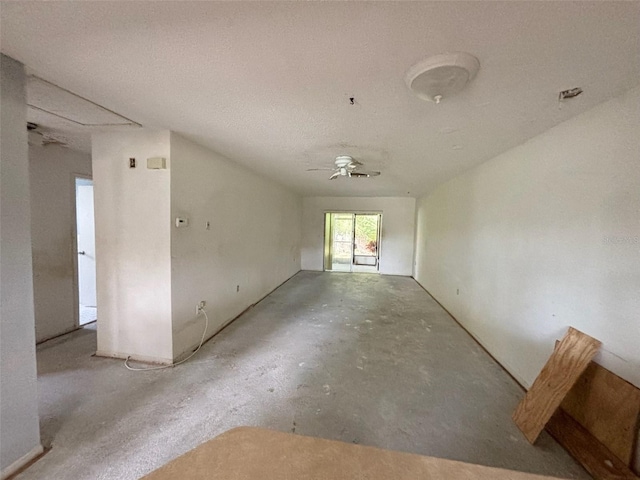 empty room with a textured ceiling and ceiling fan