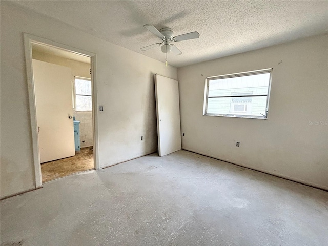 unfurnished bedroom featuring a textured ceiling and ceiling fan