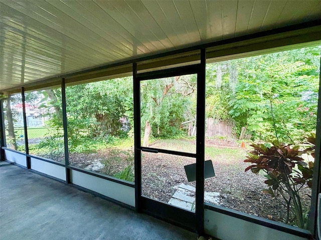 unfurnished sunroom with wooden ceiling