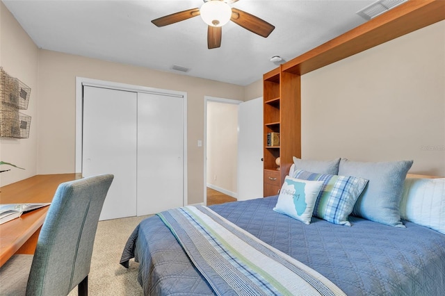 carpeted bedroom featuring a closet and ceiling fan