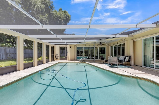 view of swimming pool featuring a lanai, a patio, an outdoor hangout area, and ceiling fan