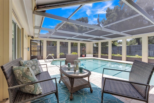 view of swimming pool with glass enclosure and a patio