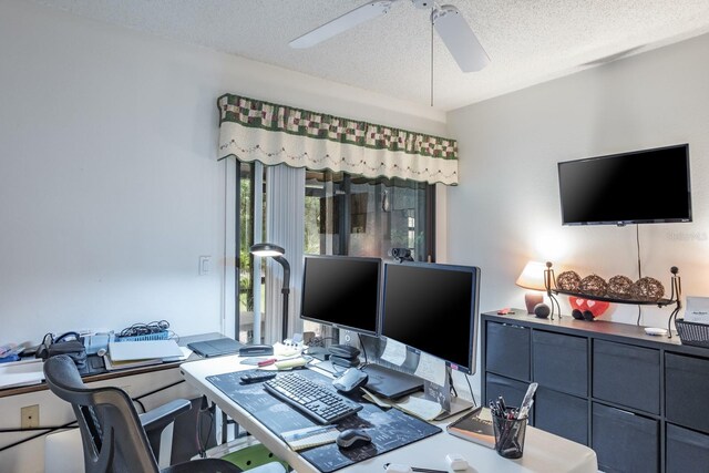 office area with a textured ceiling and ceiling fan