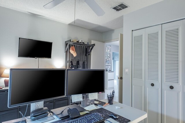 office featuring a textured ceiling and ceiling fan