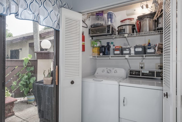 clothes washing area featuring separate washer and dryer and light tile patterned floors