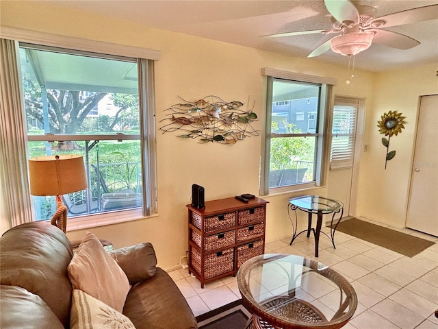 living area featuring light tile patterned flooring and ceiling fan