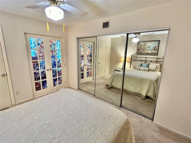 unfurnished bedroom featuring french doors, ceiling fan, carpet floors, and a closet