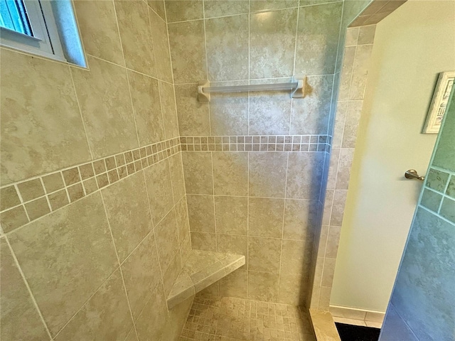 bathroom with a tile shower