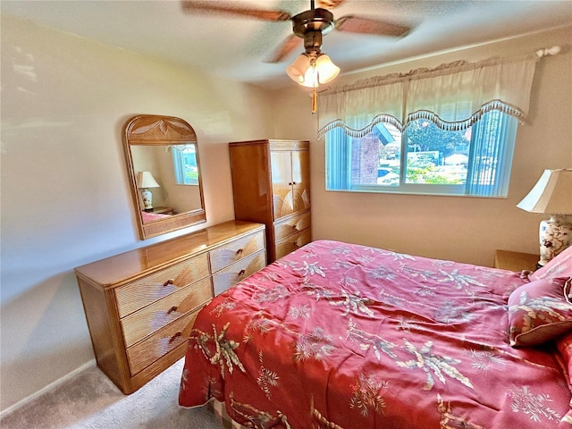 bedroom featuring ceiling fan, carpet, and multiple windows