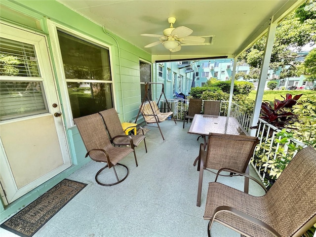 sunroom / solarium featuring ceiling fan