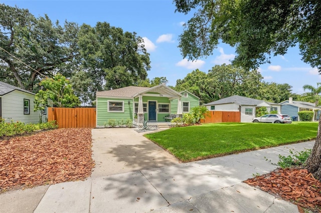 view of front of property featuring covered porch and a front lawn