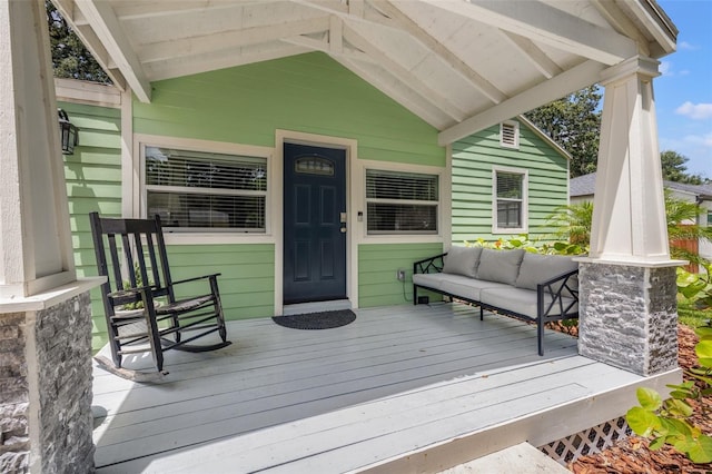 deck featuring a porch and an outdoor hangout area