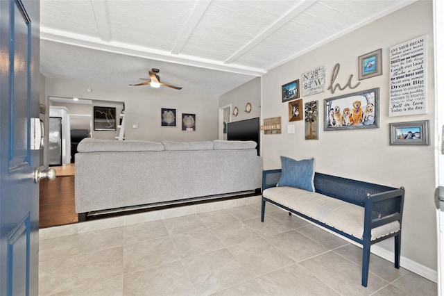 living room with ceiling fan and light tile patterned floors