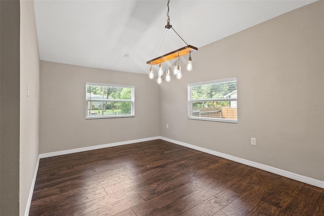 unfurnished room featuring dark wood-type flooring and lofted ceiling