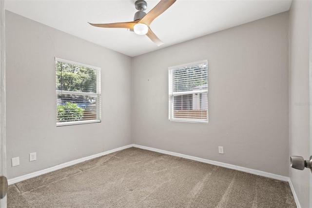 carpeted empty room featuring ceiling fan