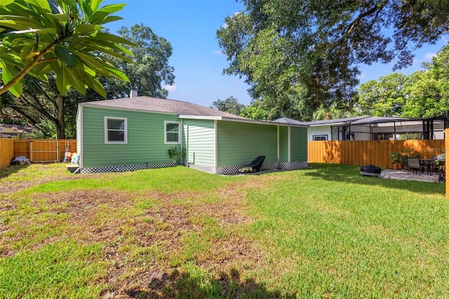 rear view of property with a yard