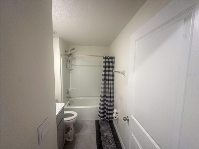 full bathroom with vanity, toilet, shower / bathtub combination with curtain, tile patterned floors, and a textured ceiling