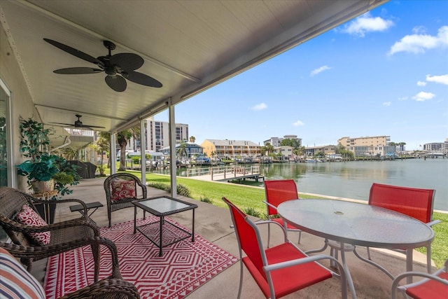 view of patio / terrace featuring ceiling fan and a water view