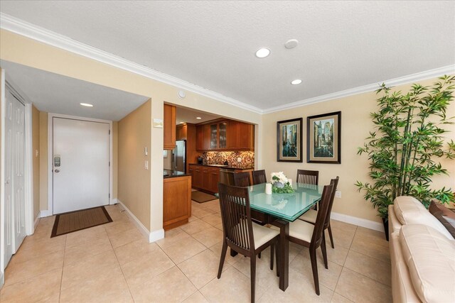 dining area with crown molding and light tile patterned floors