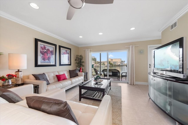 tiled living room with ornamental molding and ceiling fan