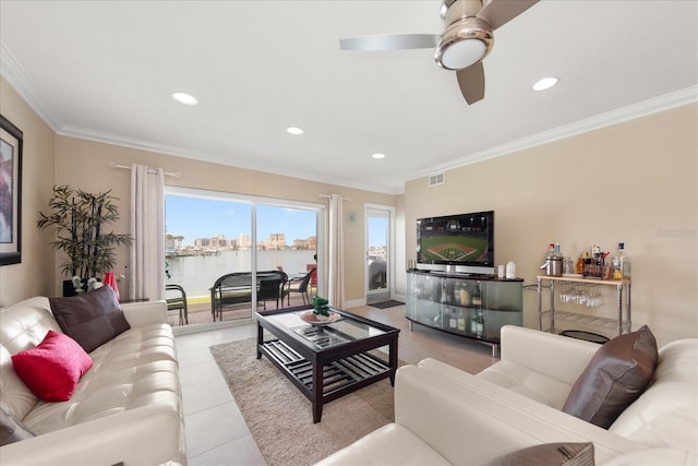 tiled living room featuring ornamental molding and ceiling fan