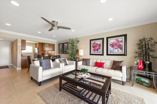 living room with ornamental molding, ceiling fan, and light tile patterned flooring