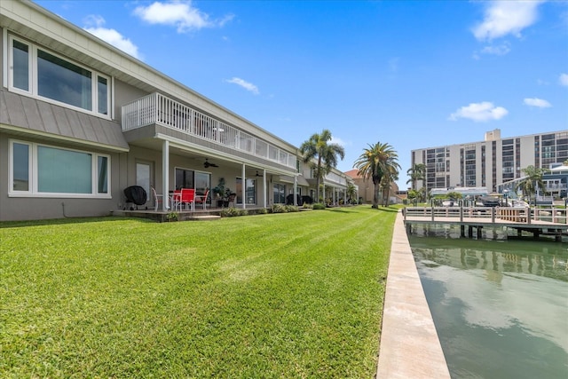 exterior space with a water view and a lawn