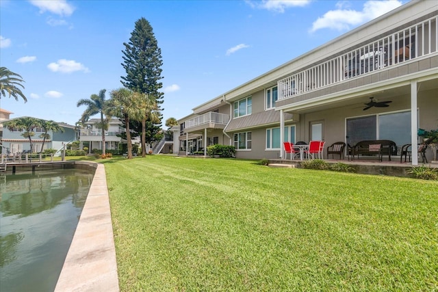 exterior space with a water view and ceiling fan