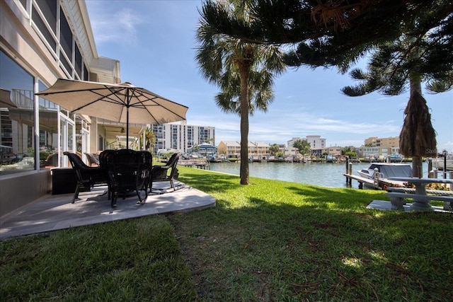 view of yard featuring a dock and a water view