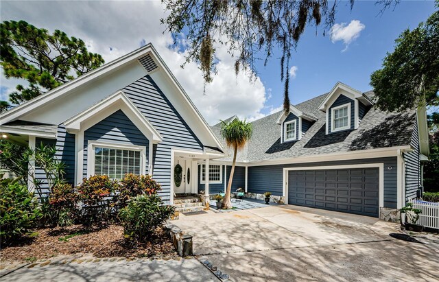 view of front of house featuring a garage and central AC unit