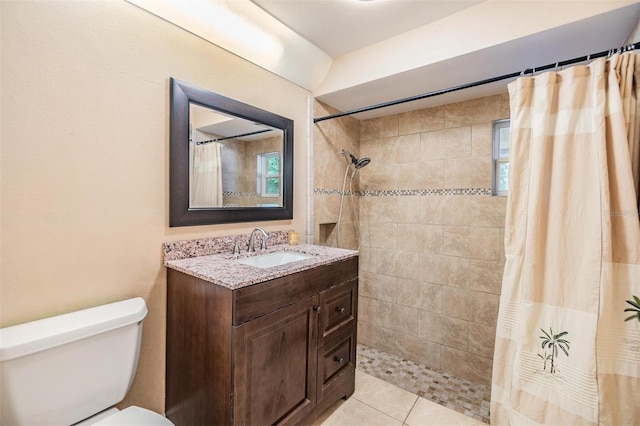 bathroom with tile patterned floors, vanity, a shower with curtain, and toilet